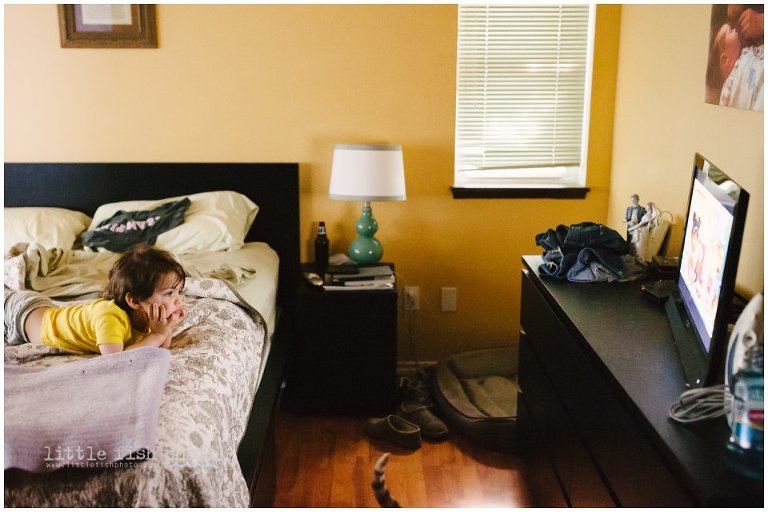 boy watches TV in bedroom