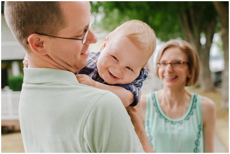 boy giggles while dad holds him