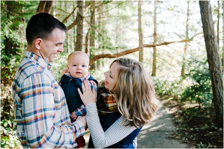 family takes fall walk with one year old boy