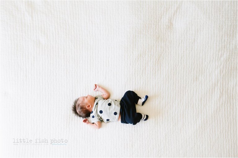 sleepy little baby on a big bed - Poulsbo Lifestyle Newborn Photographer