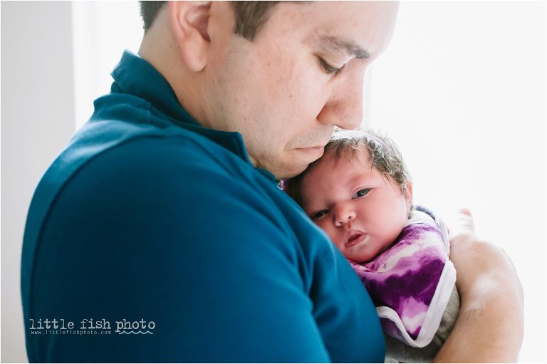 father snuggles new daughter - Bremerton Lifestyle Newborn Photographer