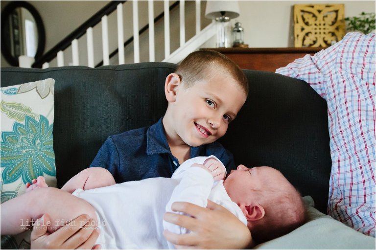 boy holds baby brother - Poulsbo Lifestyle Newborn Photographer